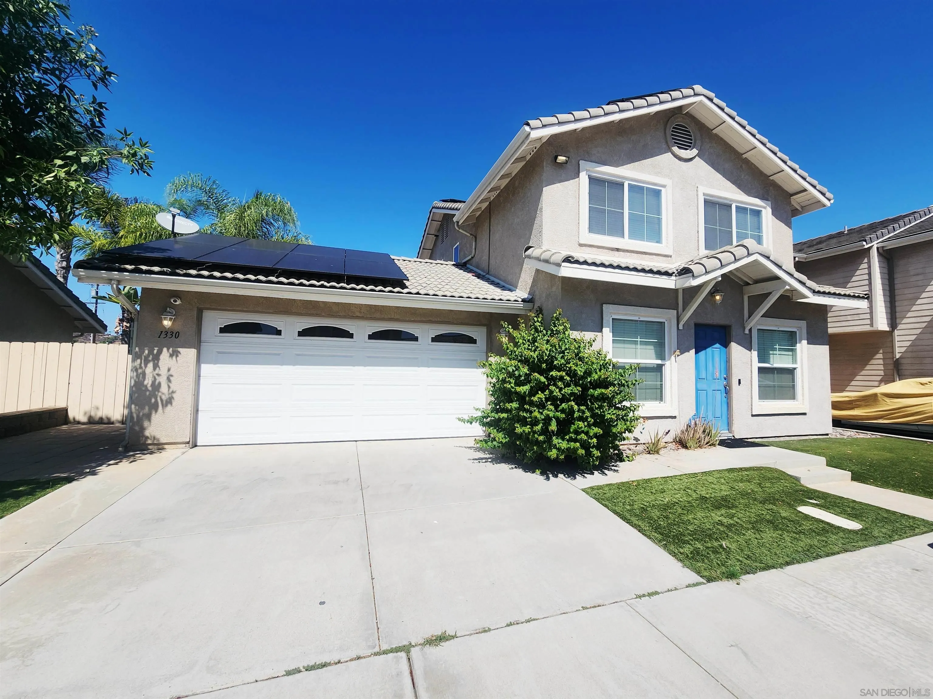 1330 Wendell Cutting Court El Cajon, CA 92021 - Photo 1 of 21 a front view of a house with a yard and garage