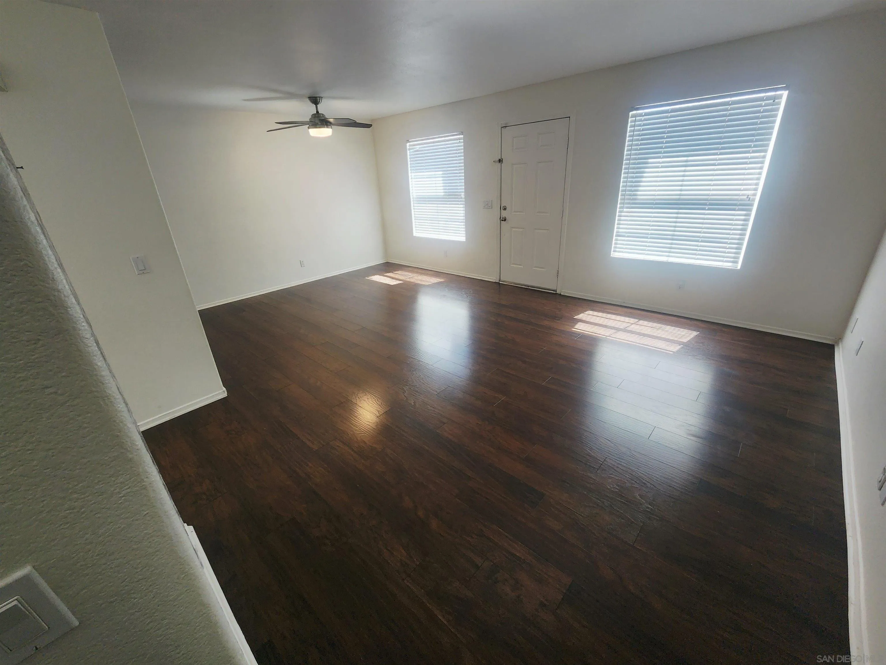 1330 Wendell Cutting Court El Cajon, CA 92021 - Photo 12 of 21 an empty room with wooden floor and windows