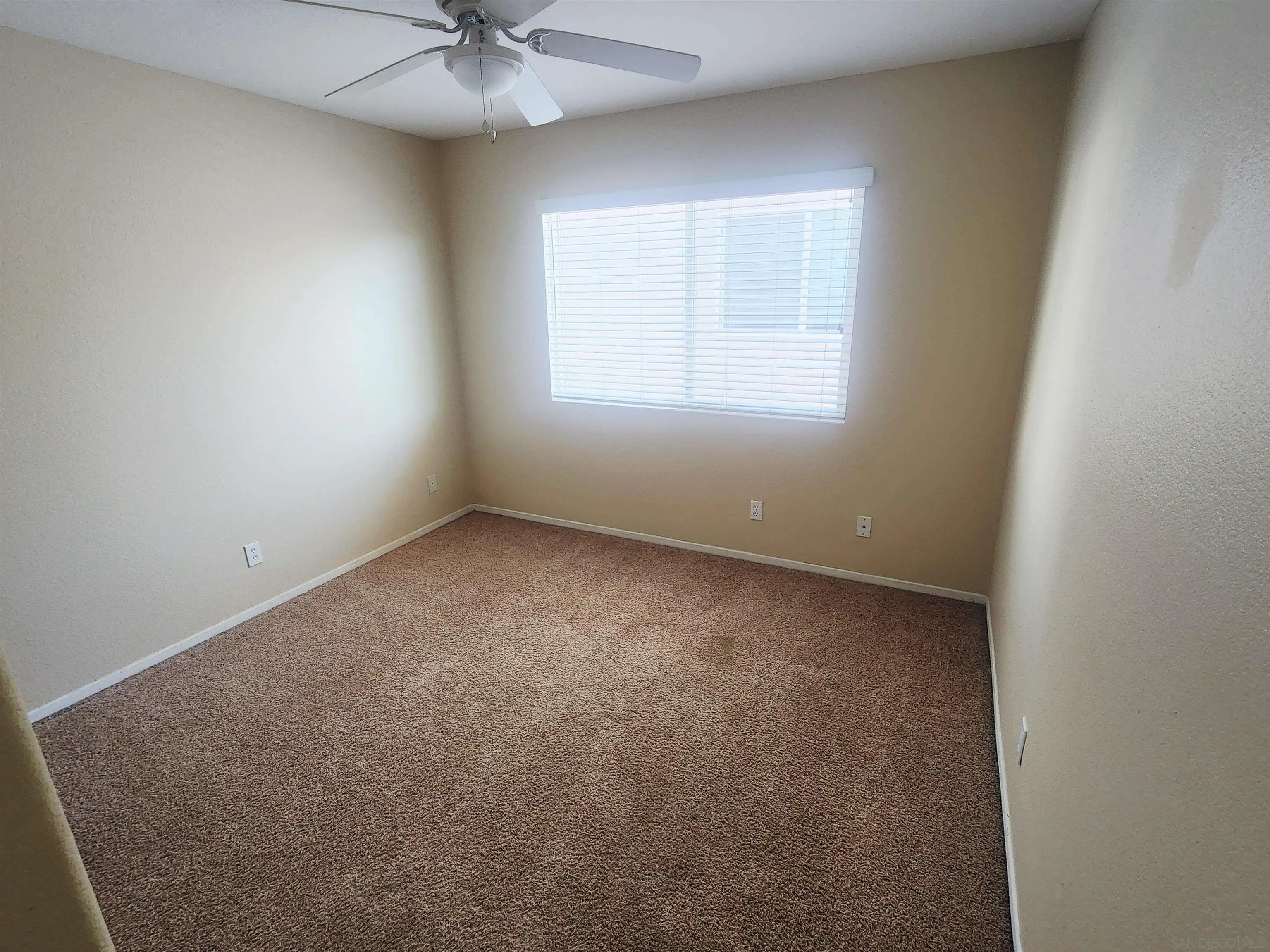1330 Wendell Cutting Court El Cajon, CA 92021 - Photo 15 of 21 an empty room with a chandelier fan and windows