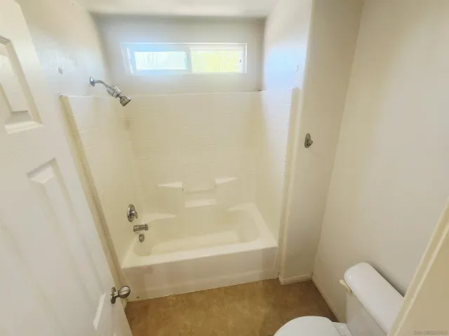 a bathroom with a tub and shower