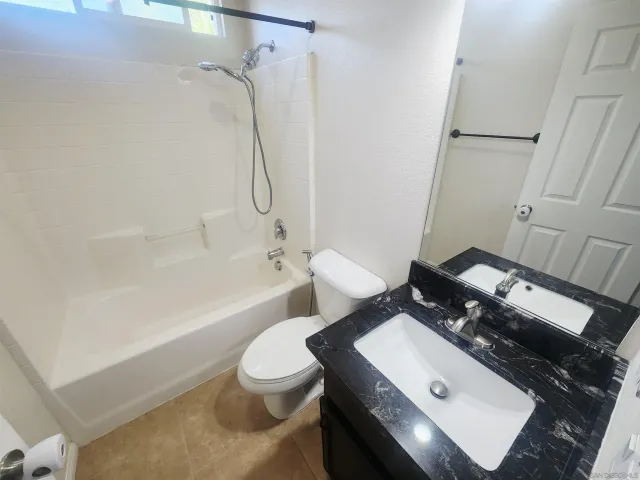 a bathroom with a toilet a sink and bathtub