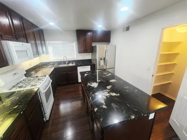 a kitchen with a sink stove and cabinets
