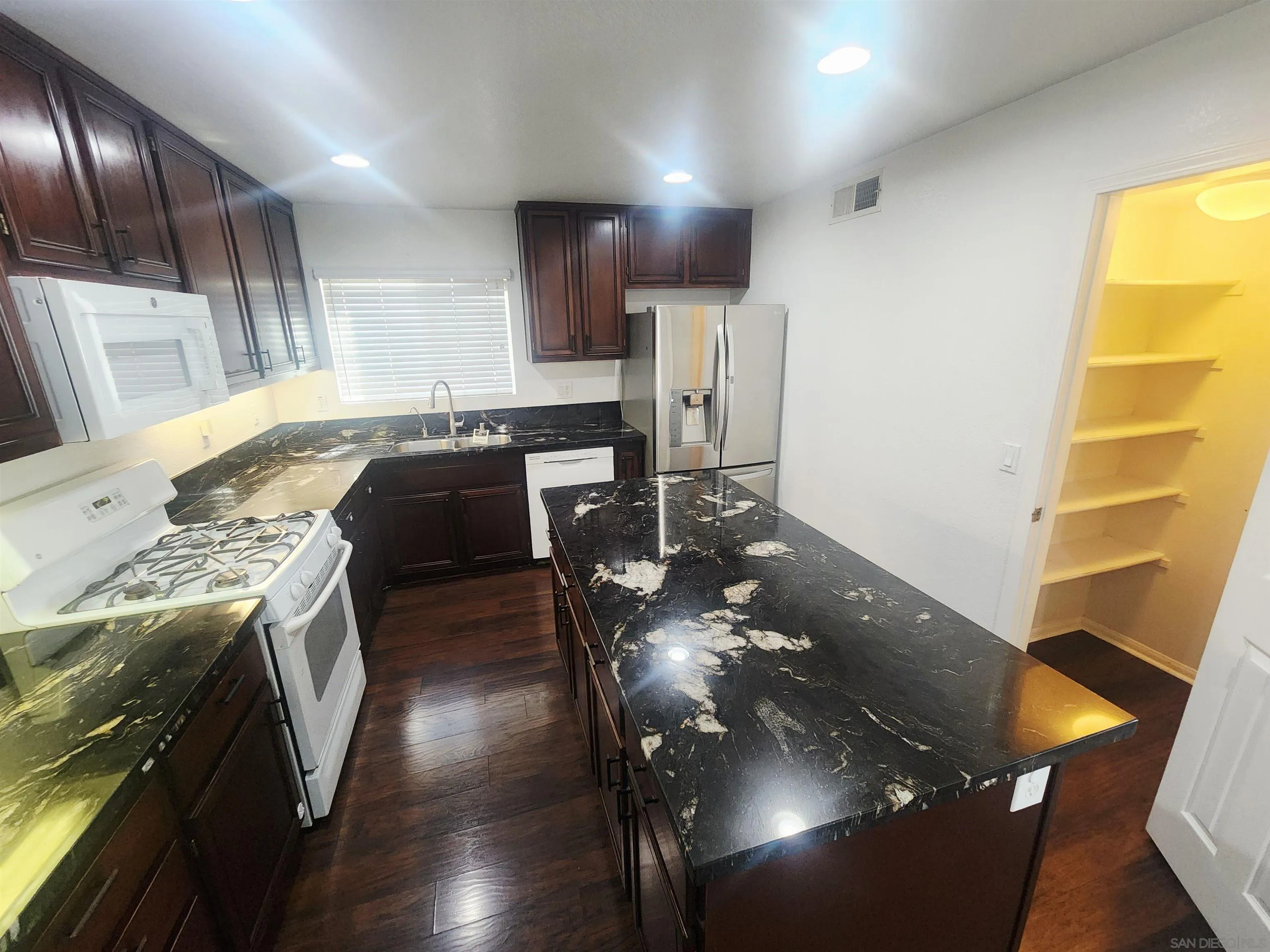 1330 Wendell Cutting Court El Cajon, CA 92021 - Photo 3 of 21 a kitchen with a sink stove and cabinets