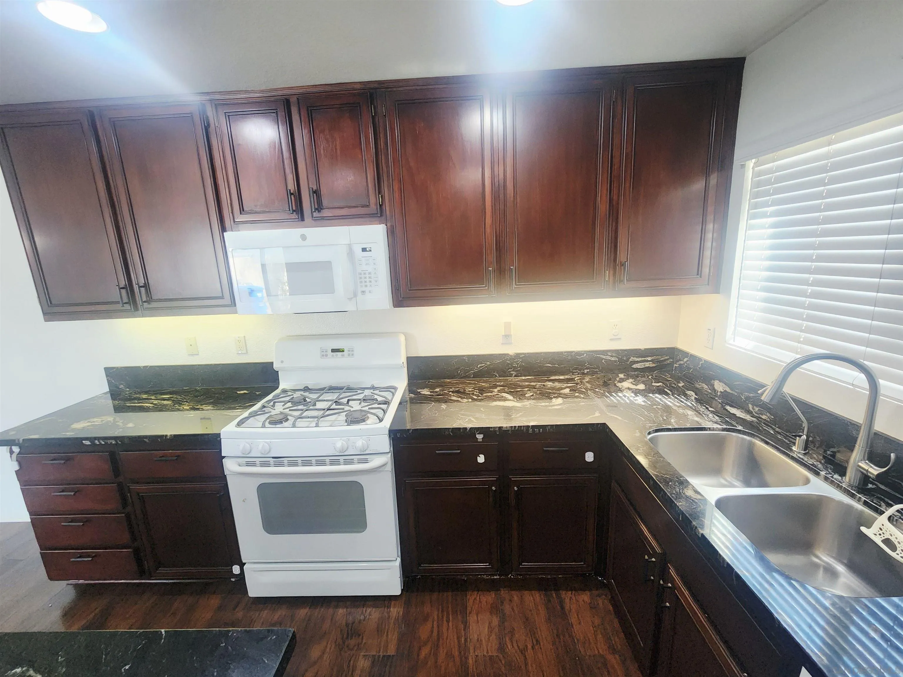 1330 Wendell Cutting Court El Cajon, CA 92021 - Photo 4 of 21 a kitchen with a stove sink and cabinets