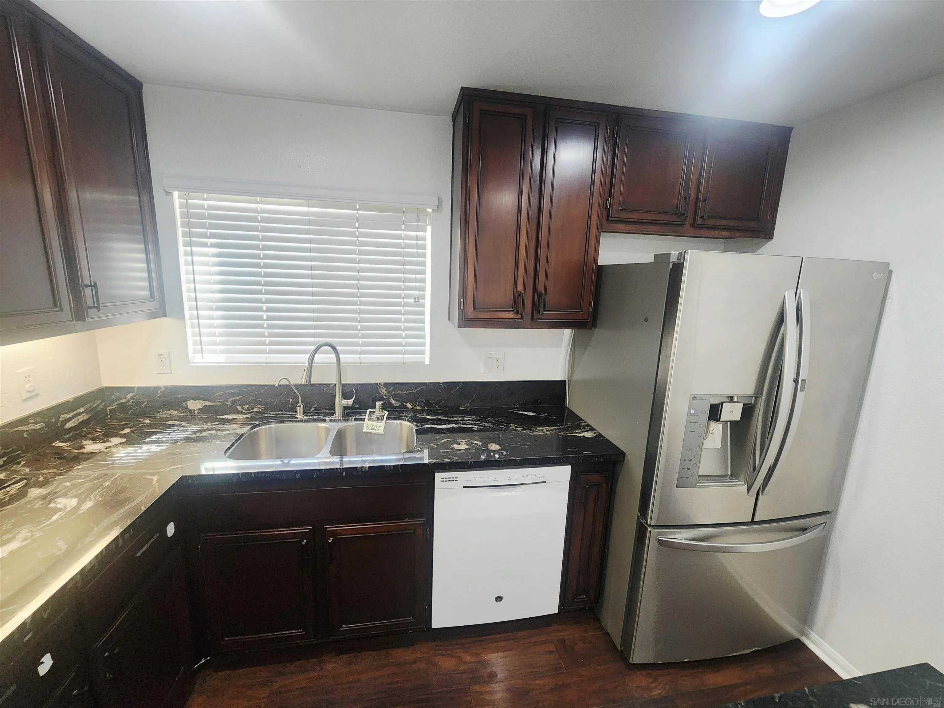1330 Wendell Cutting Court El Cajon, CA 92021 - Photo 5 of 21 a kitchen with a refrigerator sink and cabinets