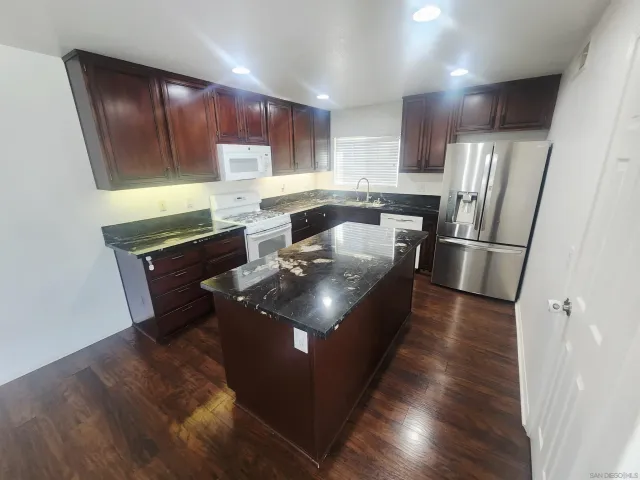 a kitchen with wooden cabinets and a stainless steel appliances
