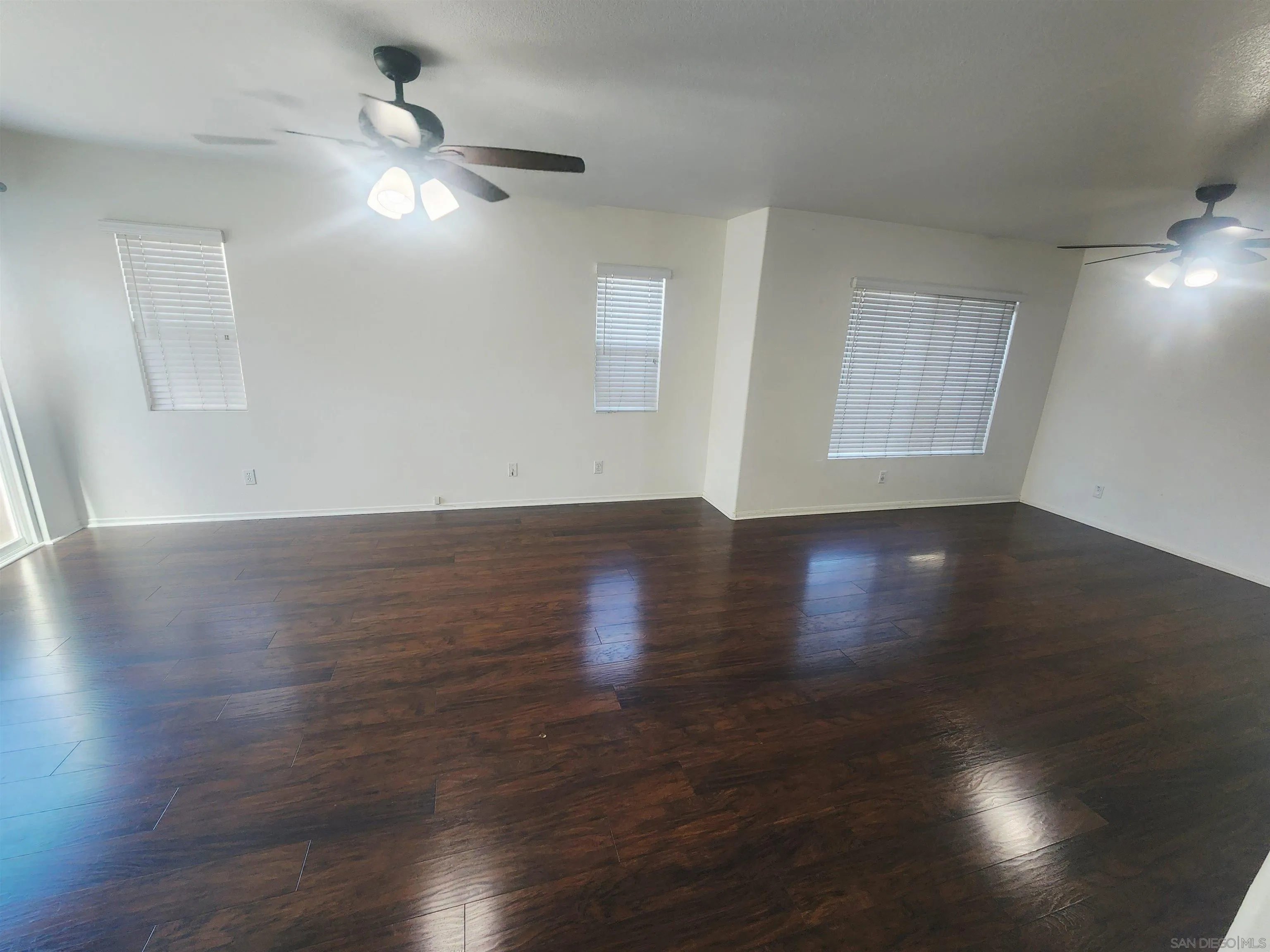 1330 Wendell Cutting Court El Cajon, CA 92021 - Photo 9 of 21 a view of an empty room with wooden floor and a window