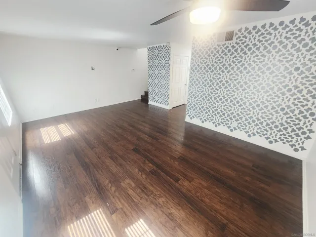 an empty room with wooden floor