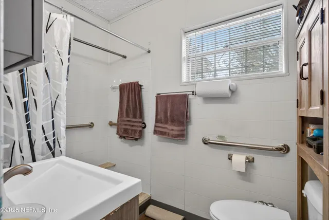 a bathroom with a sink toilet and a mirror