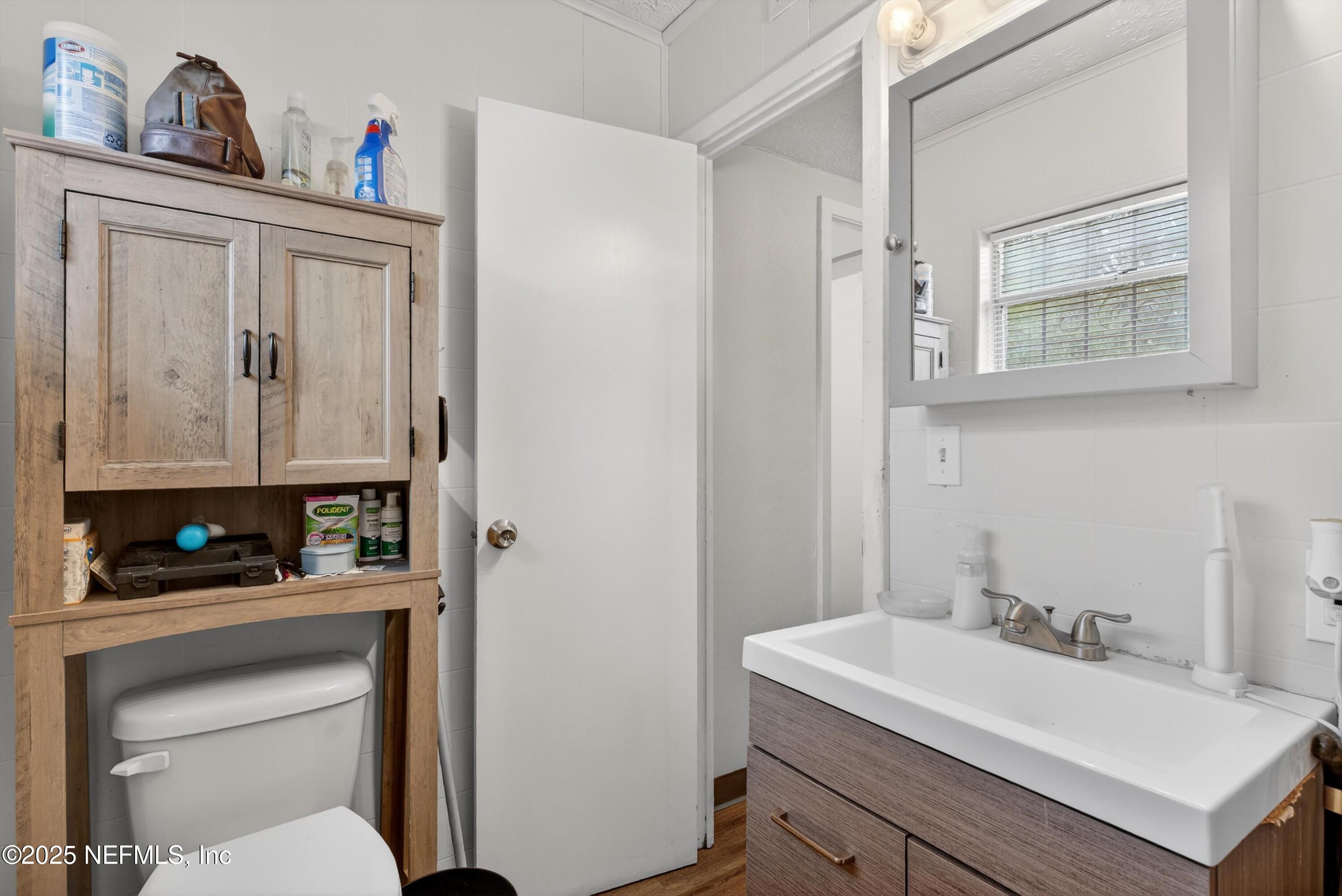 2570 Spirea Street Jacksonville, FL 32209 - Photo 13 of 19 a bathroom with a sink toilet and a mirror