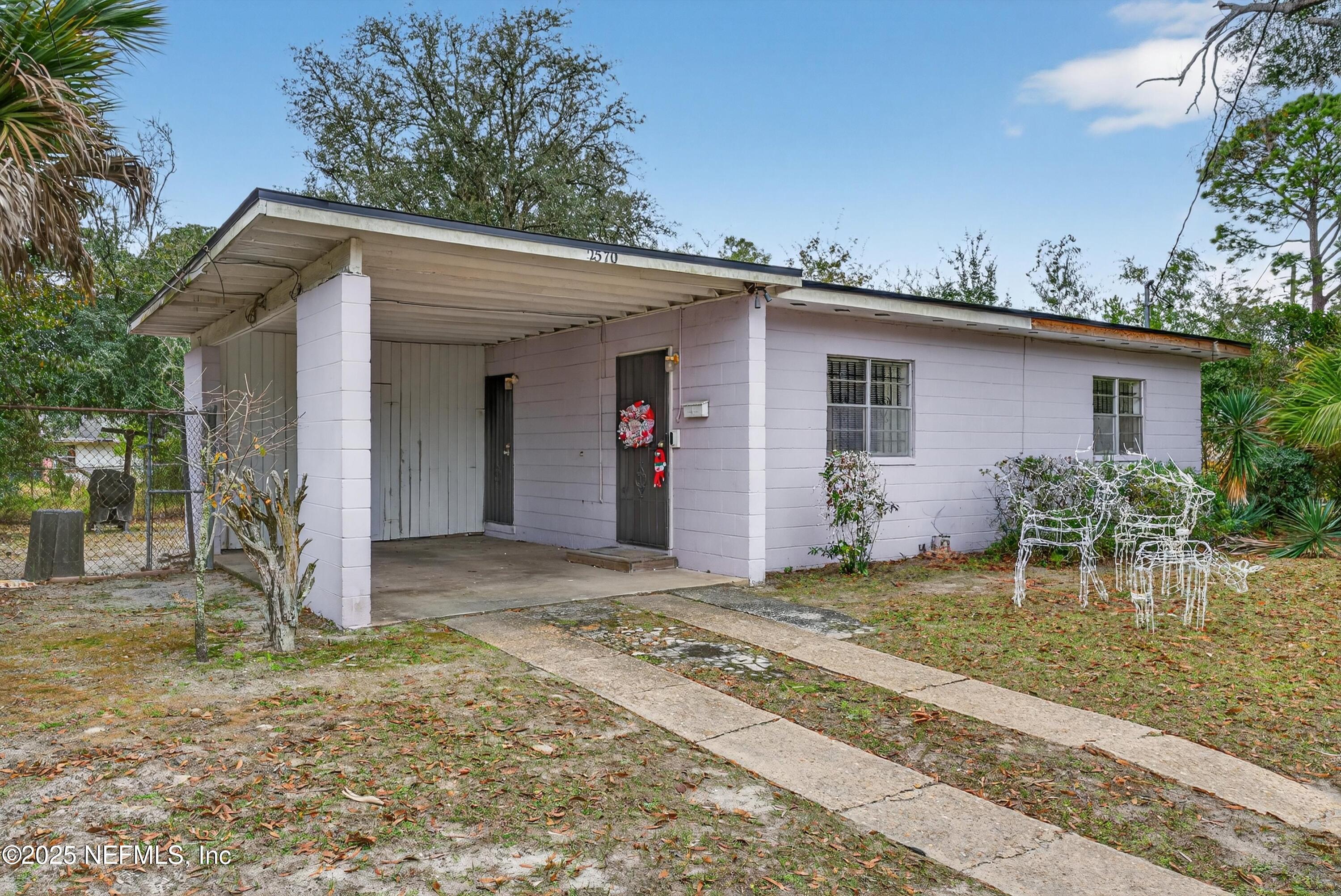 2570 Spirea Street Jacksonville, FL 32209 - Photo 3 of 19 a backyard of a house with yard and seating space