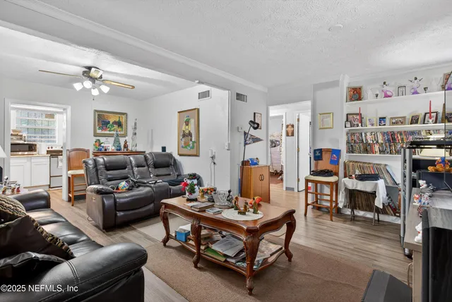 a kitchen with a refrigerator and a stove top oven