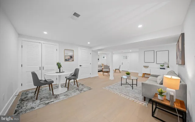 a living room with furniture a rug and a window