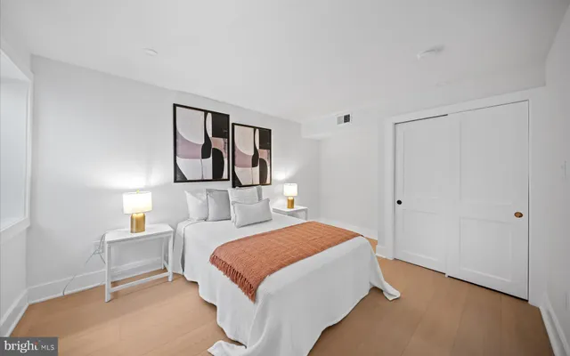 a bedroom with a bed and a painting on the wall