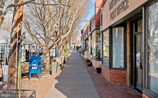 a view of a patio with chairs and a table and chairs under an umbrella