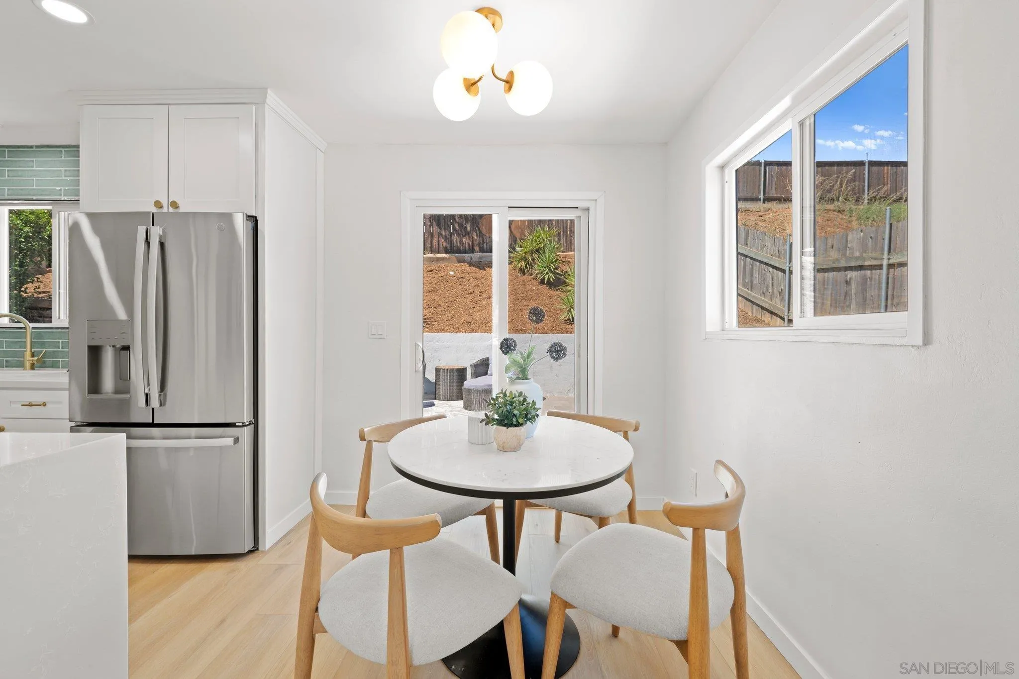 9117 Heatherdale Street Santee, CA 92071 - Photo 12 of 31 a kitchen with stainless steel appliances granite countertop a dining table and chairs