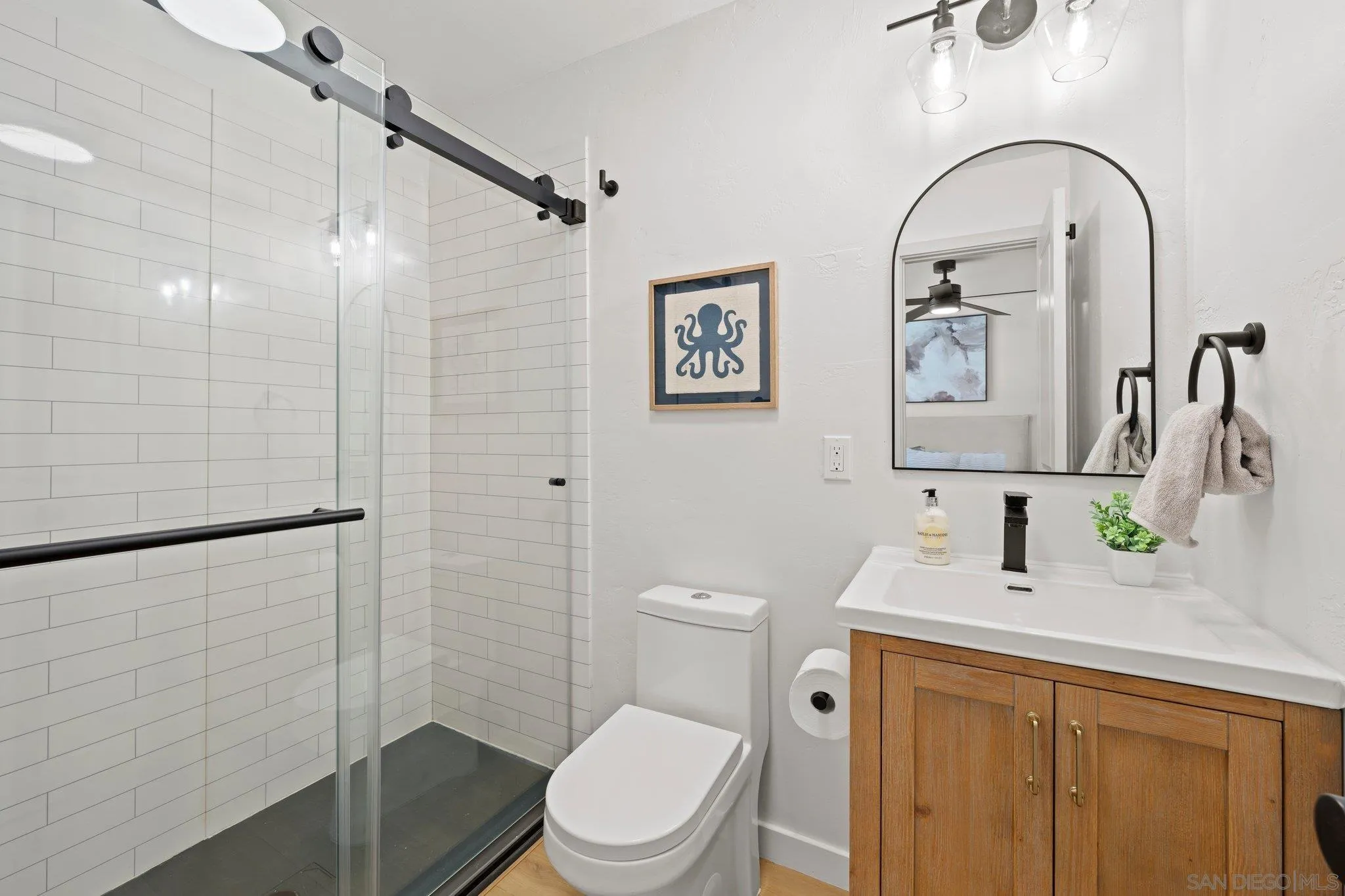 9117 Heatherdale Street Santee, CA 92071 - Photo 23 of 31 a bathroom with a toilet sink and shower