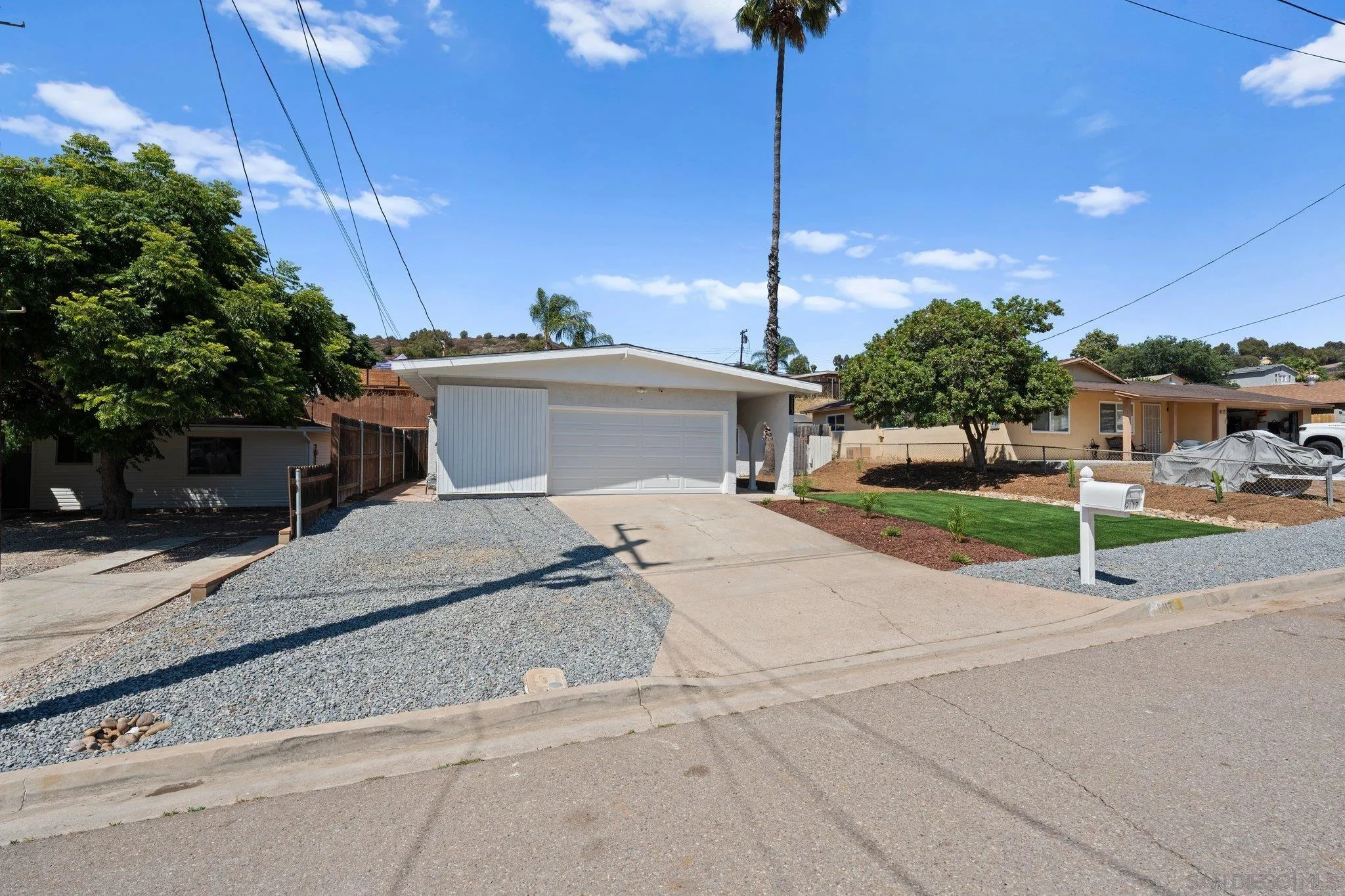 9117 Heatherdale Street Santee, CA 92071 - Photo 29 of 31 a white house with a yard and plants