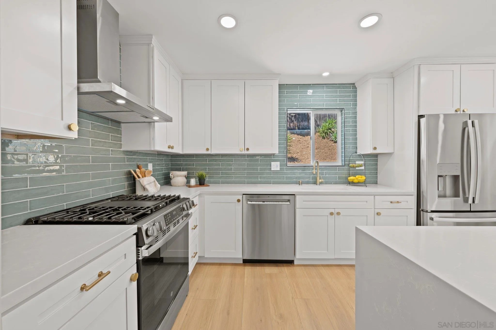 9117 Heatherdale Street Santee, CA 92071 - Photo 8 of 31 a kitchen with stainless steel appliances granite countertop a stove a sink dishwasher and a refrigerator