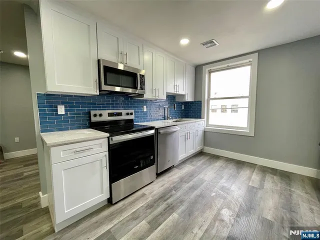 a kitchen with a white stove top oven and sink