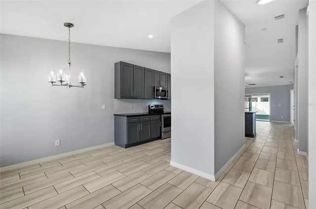 a view of a kitchen with a sink and dishwasher with wooden floor