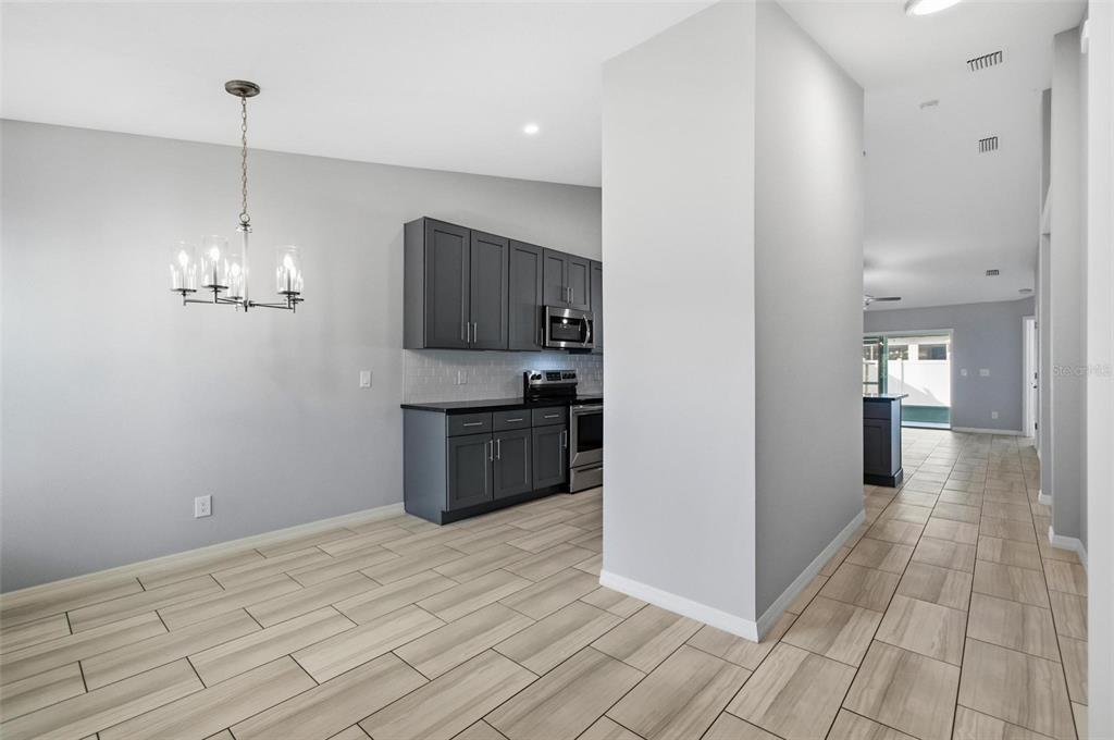 2 Lynton Place, Unit B Palm Coast, FL 32137 - Photo 14 of 51 a view of a kitchen with a sink and dishwasher with wooden floor