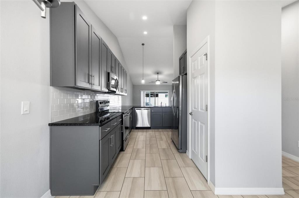 2 Lynton Place, Unit B Palm Coast, FL 32137 - Photo 15 of 51 a kitchen with stainless steel appliances granite countertop a refrigerator and a sink