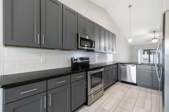 a kitchen with a sink cabinets and stainless steel appliances