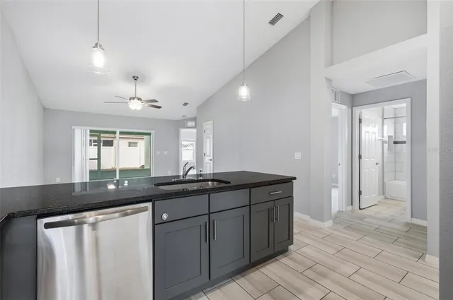 a kitchen with a sink and refrigerator