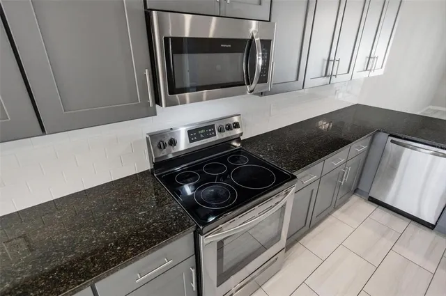 a kitchen with a stove and a microwave