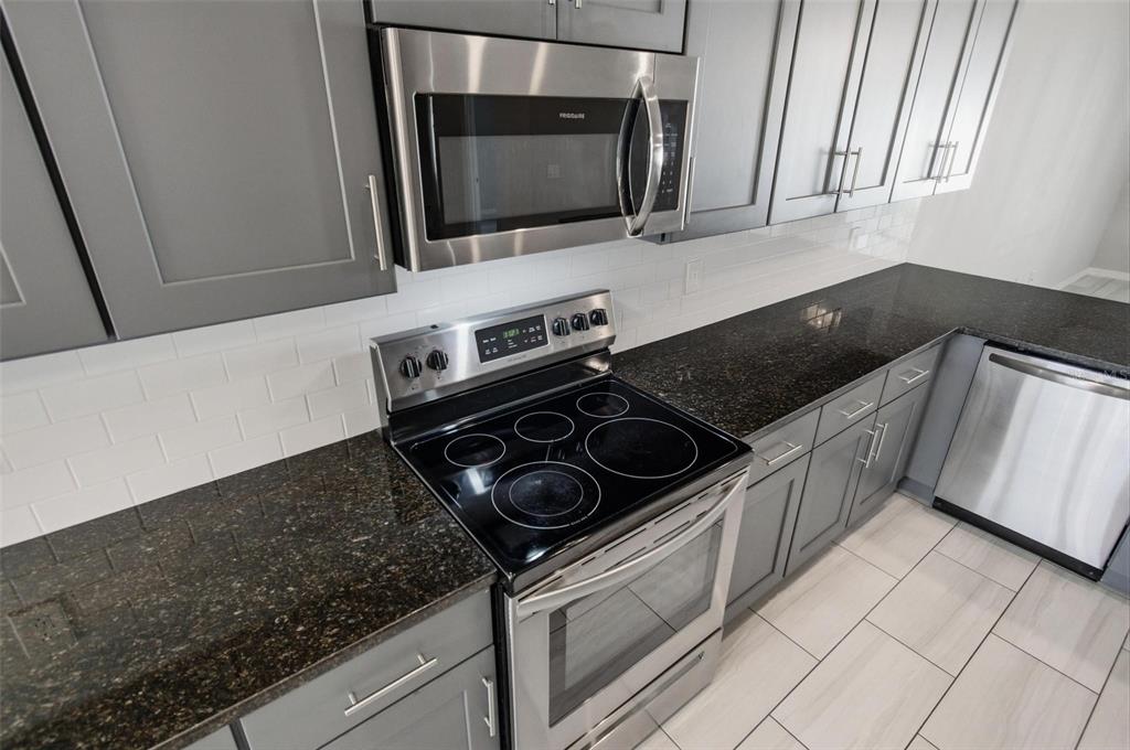 2 Lynton Place, Unit B Palm Coast, FL 32137 - Photo 22 of 51 a kitchen with a stove and a microwave