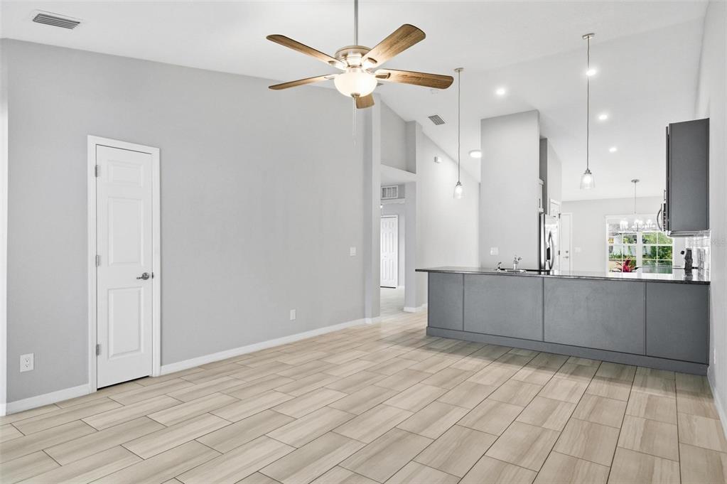 2 Lynton Place, Unit B Palm Coast, FL 32137 - Photo 25 of 51 a kitchen with stainless steel appliances kitchen island granite countertop a refrigerator a sink and white cabinets