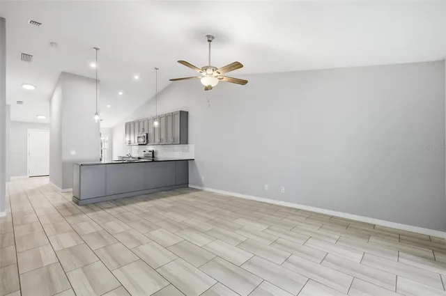 a large kitchen with stainless steel appliances lots of counter top space and cabinets