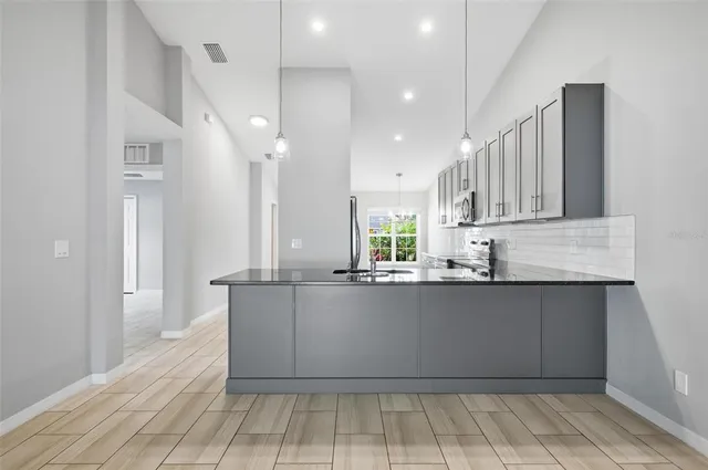 wooden floor in an empty room with a ceiling fan