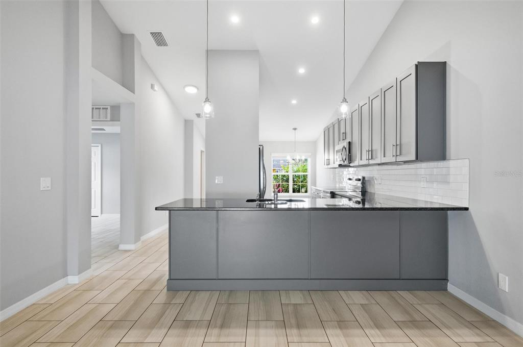 2 Lynton Place, Unit B Palm Coast, FL 32137 - Photo 27 of 51 a large kitchen with stainless steel appliances lots of counter top space and cabinets