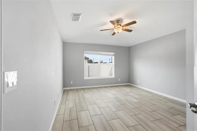 wooden floor in an empty room with a window