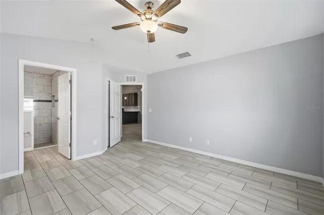 a bathroom with a granite countertop sink a toilet and a mirror