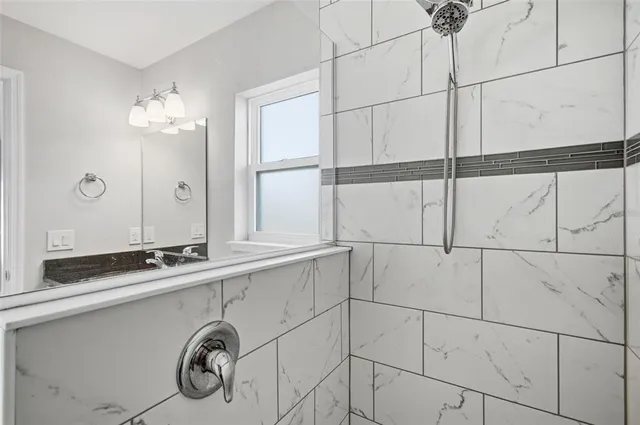 a bathroom with a granite countertop sink a toilet and a mirror