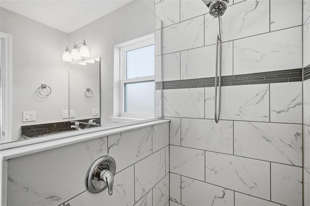 2 Lynton Place, Unit B Palm Coast, FL 32137 - Photo 34 of 51 a bathroom with a sink and a mirror