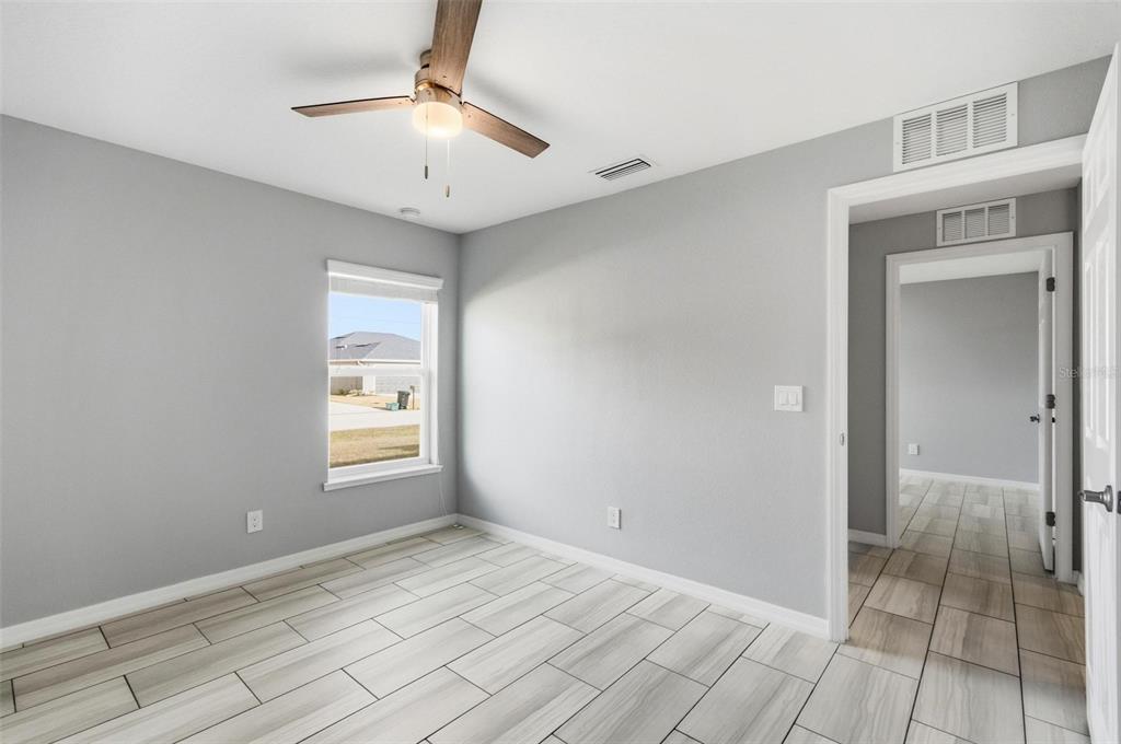 2 Lynton Place, Unit B Palm Coast, FL 32137 - Photo 41 of 51 a view of an empty room with window and chandelier fan