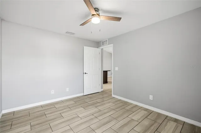 a bathroom with a granite countertop sink mirror toilet and bathtub