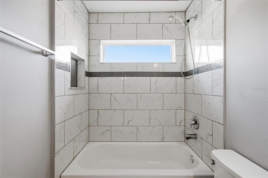 2 Lynton Place, Unit B Palm Coast, FL 32137 - Photo 45 of 51 a bathroom with a bathtub and a shower