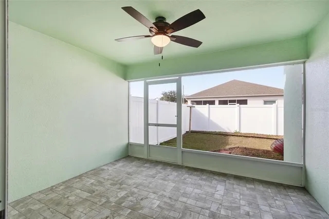 en empty room with window and a ceiling fan