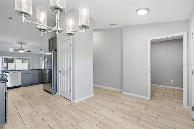 a view of a kitchen with a sink and a refrigerator