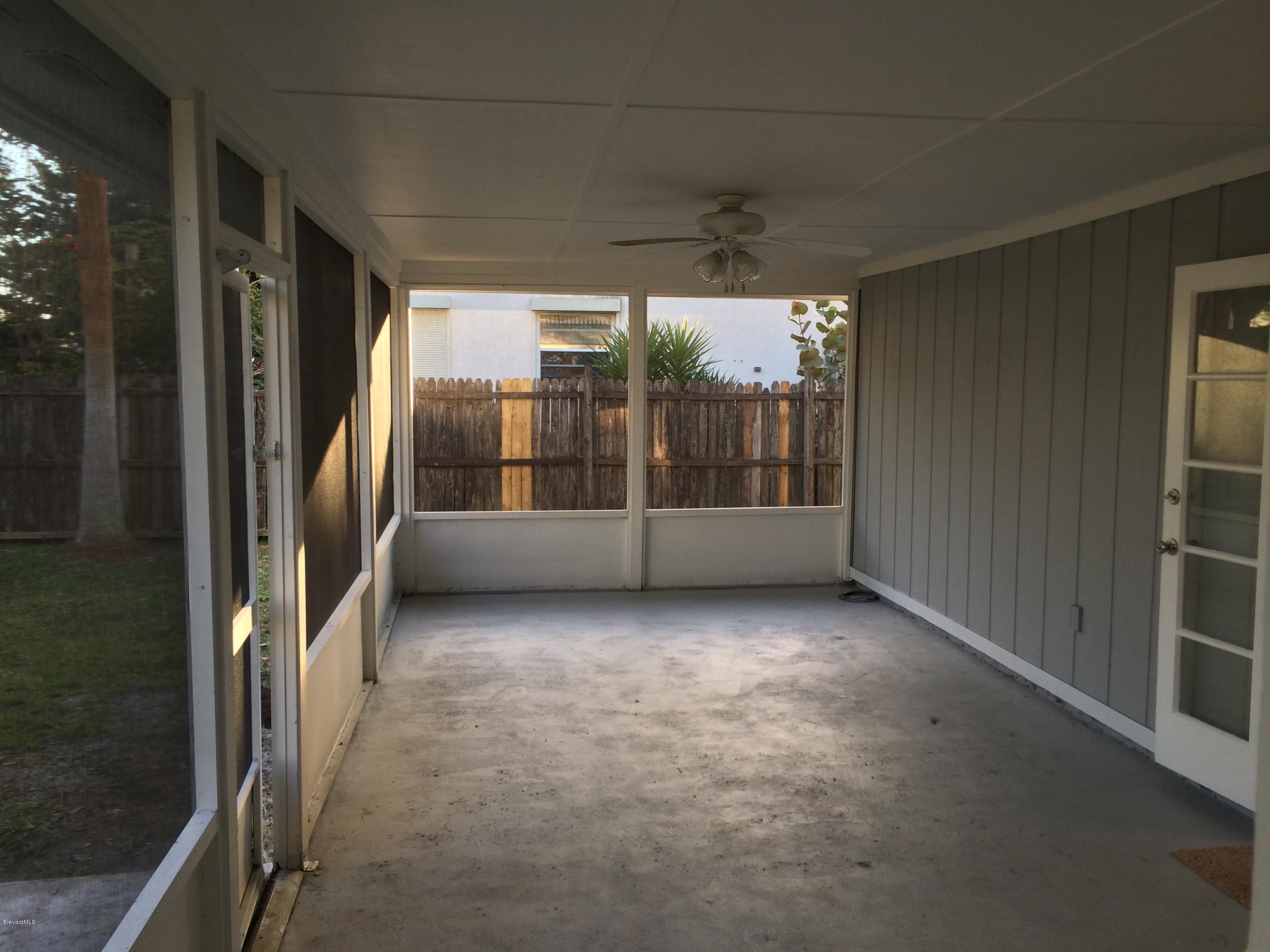 6151 Corning Road Cocoa, FL 32927 - Photo 1 of 13 a view of an empty room with a sliding door and balcony