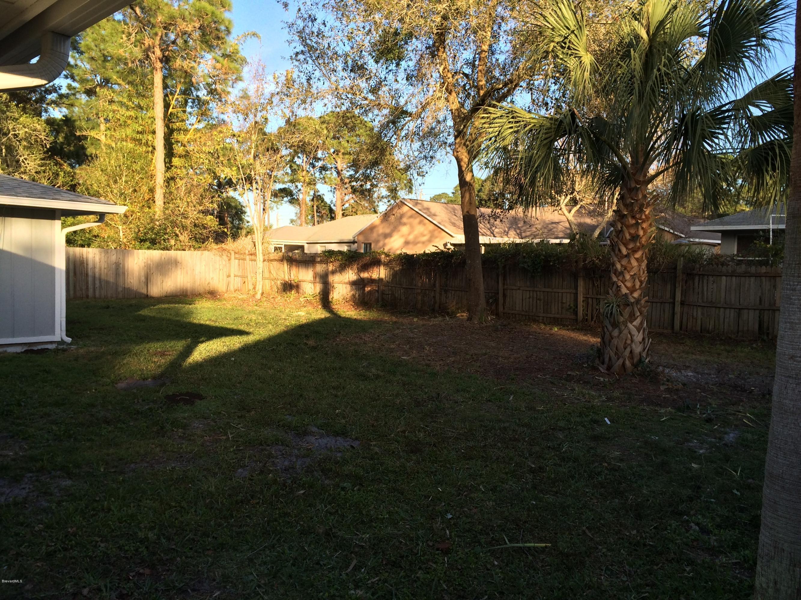 6151 Corning Road Cocoa, FL 32927 - Photo 2 of 13 a backyard of a house with lots of green space