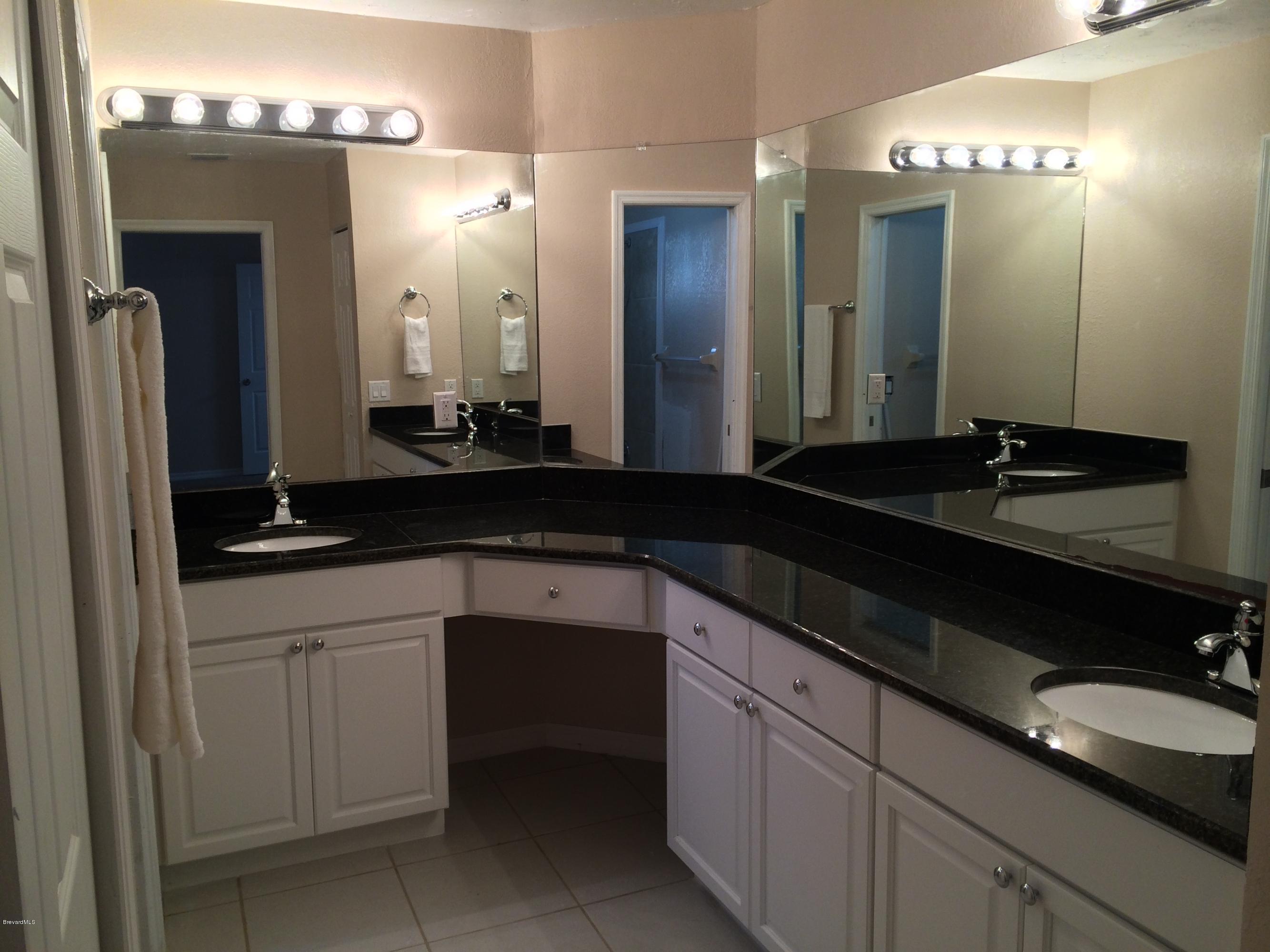 6151 Corning Road Cocoa, FL 32927 - Photo 12 of 13 a bathroom with a granite countertop sink and a mirror