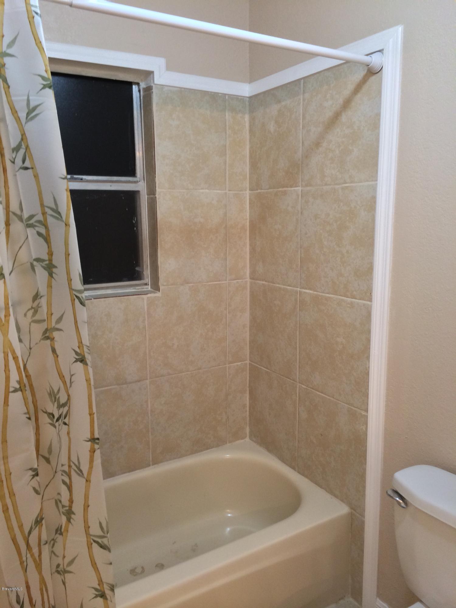6151 Corning Road Cocoa, FL 32927 - Photo 13 of 13 a bathroom with a bathtub and a toilet