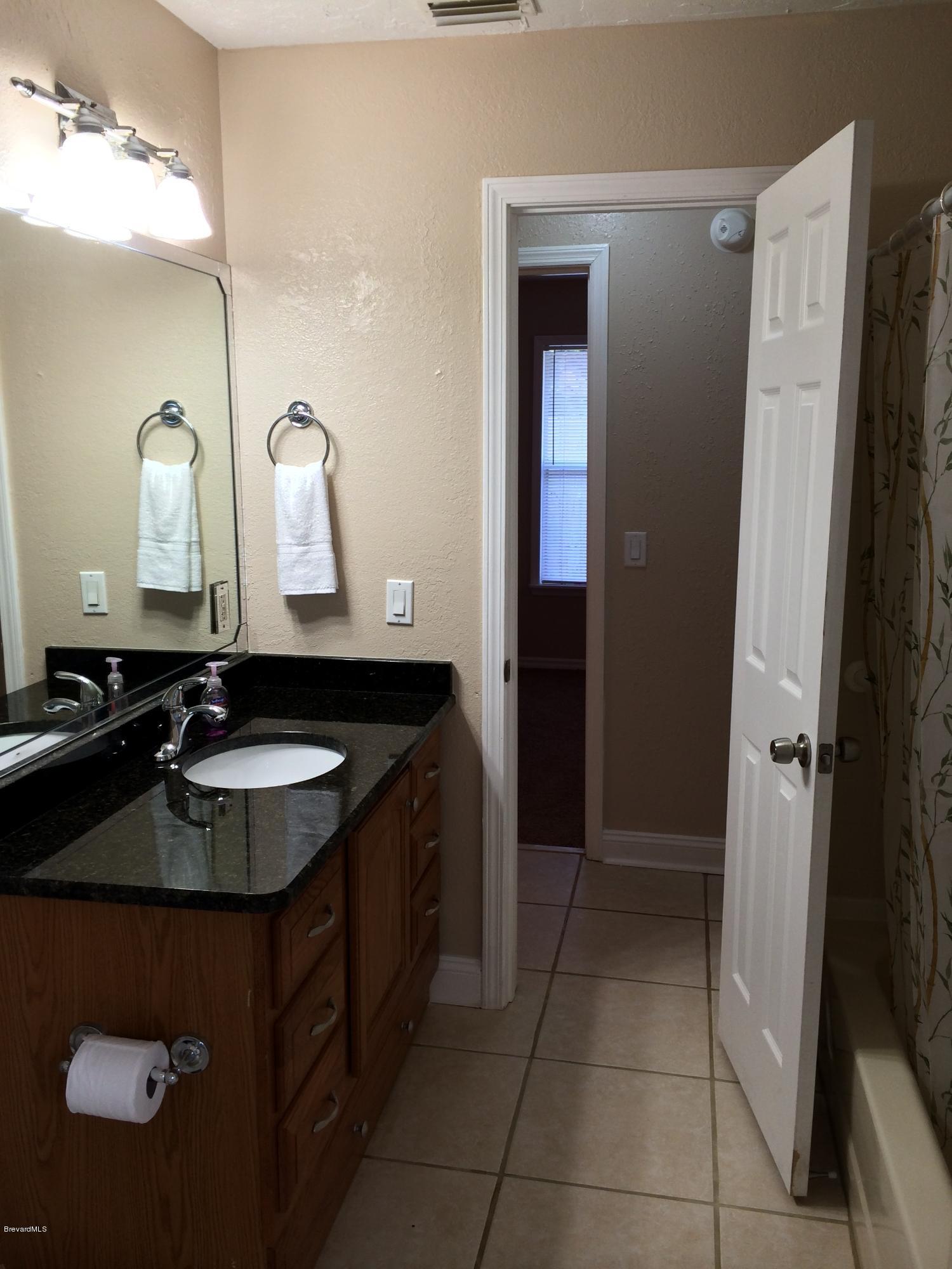 6151 Corning Road Cocoa, FL 32927 - Photo 6 of 13 a bathroom with a sink and a mirror