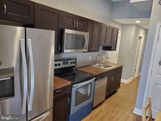 a kitchen with stainless steel appliances and wooden cabinets